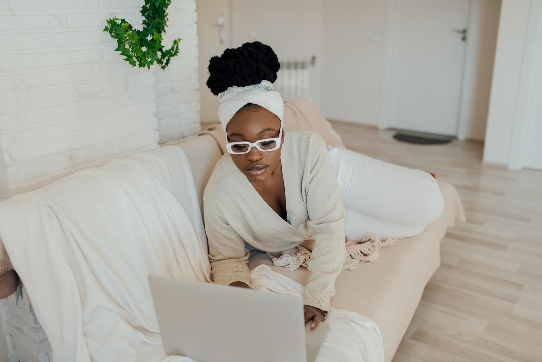 A Woman Using a Laptop on a Couch