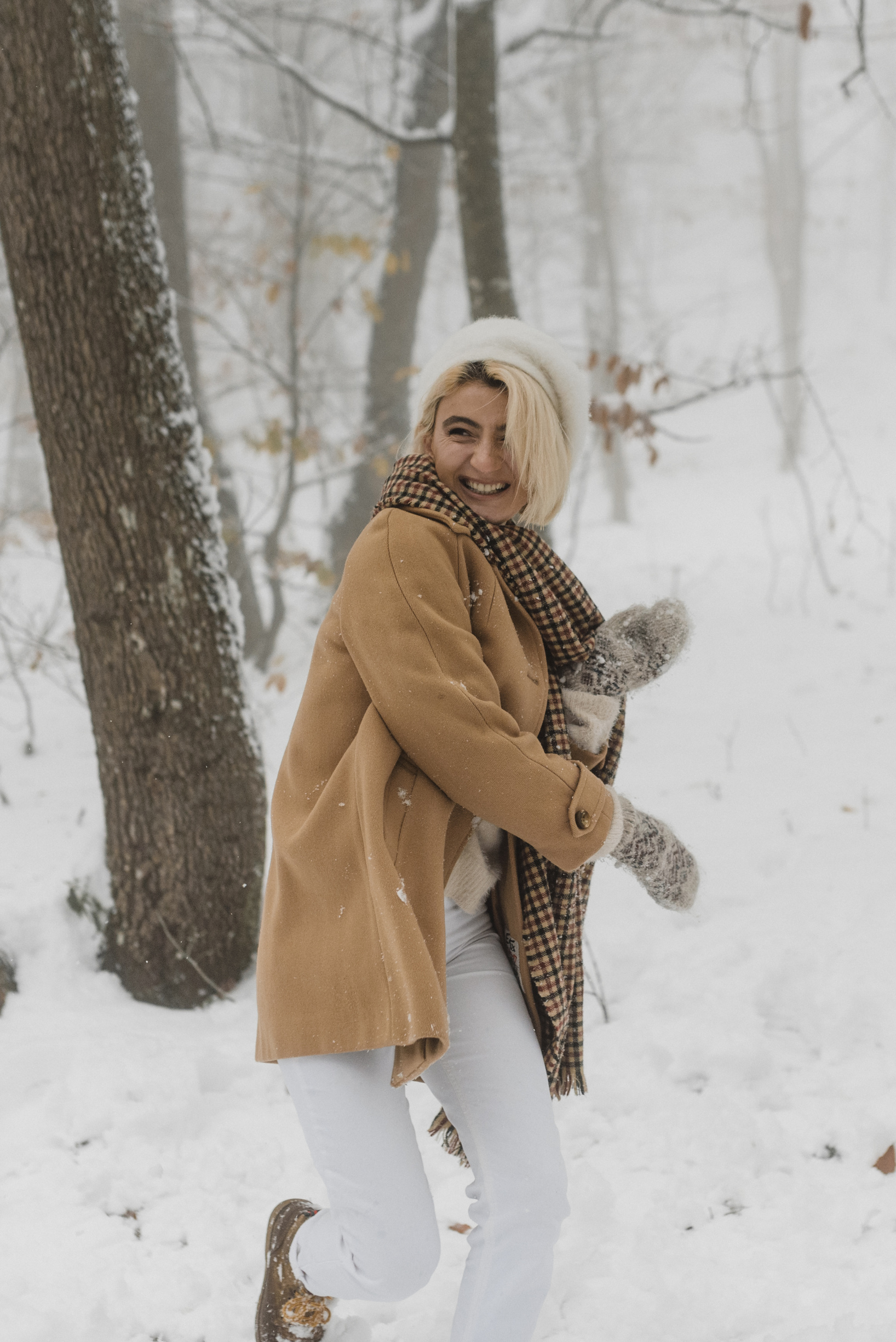 Woman in Winter Clothes Having Fun Playing in the Snow