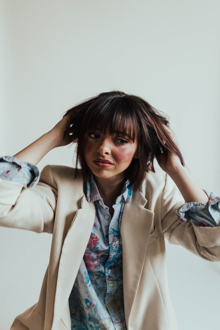 Stressed Woman Wearing Blue Long Sleeves and Blazer 